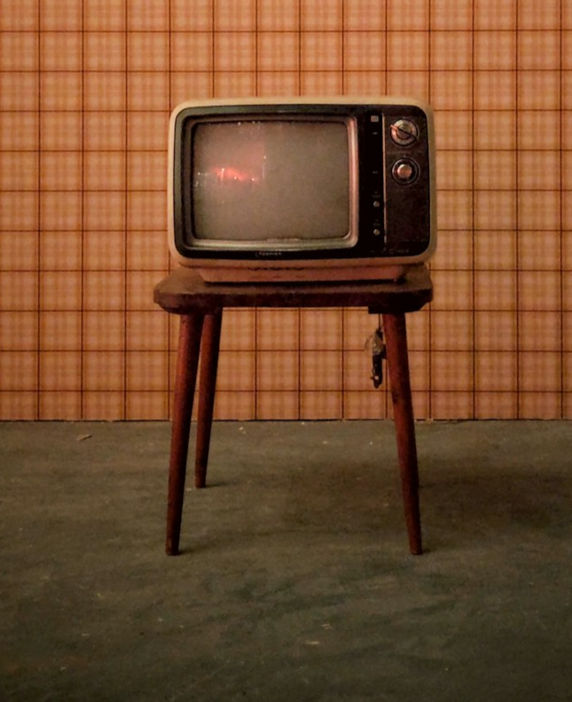 picture of dated small television set on small wooden stand